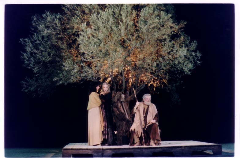 Oedipus seated under olive tree with daughters standing