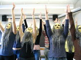 Classroom rehearsal, showing masked students in synchronized choreography.